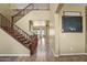 Inviting foyer with a staircase and tiled flooring leading to the rest of the home at 14430 W Windsor Ave, Goodyear, AZ 85395