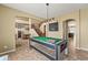 Game room with tile floors featuring a pool table and a cozy staircase at 14430 W Windsor Ave, Goodyear, AZ 85395