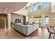 Bright living room featuring high ceilings, large windows, and modern decor at 14430 W Windsor Ave, Goodyear, AZ 85395