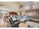 Spacious living room featuring hardwood floors, a large sectional, and open-concept design at 14430 W Windsor Ave, Goodyear, AZ 85395