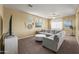 Comfortable living area with neutral walls, plush seating, and a ceiling fan at 14430 W Windsor Ave, Goodyear, AZ 85395