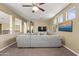 Spacious living room featuring plush carpeting, neutral tones, and large windows at 14430 W Windsor Ave, Goodyear, AZ 85395