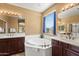 Relaxing main bathroom featuring a large tub and double sinks at 14430 W Windsor Ave, Goodyear, AZ 85395