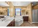 The main bathroom features a relaxing tub and lots of natural light at 14430 W Windsor Ave, Goodyear, AZ 85395