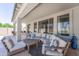 Relaxing covered patio with comfortable seating and views of the backyard, perfect for outdoor entertaining and leisure at 14430 W Windsor Ave, Goodyear, AZ 85395