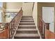 Staircase featuring carpeted steps, wood railing and side panels leading upstairs at 14430 W Windsor Ave, Goodyear, AZ 85395