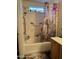 Bathroom featuring a shower-tub combo and decorative accents at 1448 E Mobile Ln, Phoenix, AZ 85040