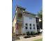 Charming two-story home featuring stucco siding, arched windows, and a welcoming entrance with an American flag at 1448 E Mobile Ln, Phoenix, AZ 85040