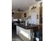 Kitchen island with a sink, modern fixtures, and adjacent dining area with ample natural light at 1448 E Mobile Ln, Phoenix, AZ 85040