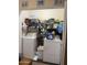 Organized laundry room featuring a washer, dryer, shelving, and ample storage space for supplies at 1448 E Mobile Ln, Phoenix, AZ 85040