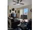 Inviting living room featuring comfortable couches, a ceiling fan, and sliding glass doors to the outdoors at 1448 E Mobile Ln, Phoenix, AZ 85040