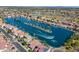 Aerial view of waterfront homes lining the lake in a beautiful lakeside community with mature palm trees at 1506 W Laurel Ave, Gilbert, AZ 85233
