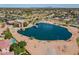 Community lake featuring sports fields, community buildings, picnic areas, and residential landscape at 1506 W Laurel Ave, Gilbert, AZ 85233