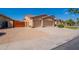 Charming single-story home with a terracotta tile roof, a three-car garage, and mature landscaping at 1506 W Laurel Ave, Gilbert, AZ 85233
