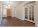 Bright foyer featuring wood flooring, a decorative chandelier, and glass French doors at 1506 W Laurel Ave, Gilbert, AZ 85233