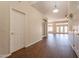 Hallway with wood floors and white walls leading into an open floor plan at 1506 W Laurel Ave, Gilbert, AZ 85233