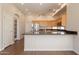 Open kitchen featuring granite counters, stainless appliances, a ceiling fan, and wood cabinets at 1506 W Laurel Ave, Gilbert, AZ 85233