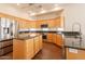Bright kitchen features stainless steel appliances, granite counters and center island with breakfast bar at 1506 W Laurel Ave, Gilbert, AZ 85233