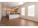 Open-concept kitchen with granite countertops, stainless steel appliances, and wood cabinets at 1506 W Laurel Ave, Gilbert, AZ 85233