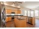 Bright kitchen features stainless steel appliances, granite counters and center island with breakfast bar at 1506 W Laurel Ave, Gilbert, AZ 85233