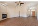 Spacious living room with a fireplace, ceiling fan, and hardwood flooring at 1506 W Laurel Ave, Gilbert, AZ 85233