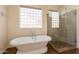 Main bath includes soaking tub and glass shower at 1506 W Laurel Ave, Gilbert, AZ 85233