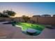 The pool has a waterfall feature and in-pool table at 1506 W Laurel Ave, Gilbert, AZ 85233