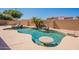 A uniquely shaped pool with a waterfall feature at 1506 W Laurel Ave, Gilbert, AZ 85233