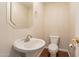 Powder room includes pedestal sink, designer mirror and lighting at 1506 W Laurel Ave, Gilbert, AZ 85233
