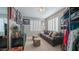 Bedroom with brown leather couch, mounted TV, natural light, and decor at 15252 N 100Th St # 1134, Scottsdale, AZ 85260