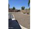 Low maintenance backyard with rock cover, shed, brick wall, and clear blue sky at 15352 W Ventura St, Surprise, AZ 85379