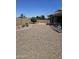 Spacious, low maintenance backyard with gravel, pavers, trees, and perimeter brick wall at 15352 W Ventura St, Surprise, AZ 85379
