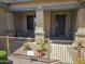 Charming covered front porch with a secure gate and seating area at 15352 W Ventura St, Surprise, AZ 85379