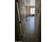 View of the hallway leading to a naturally lit living area through an open door at 15352 W Ventura St, Surprise, AZ 85379