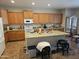 Spacious kitchen with granite countertops, island, and ample cabinet space at 15352 W Ventura St, Surprise, AZ 85379