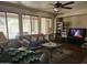 Spacious living room with large windows, ceiling fan, and comfortable furnishings at 15352 W Ventura St, Surprise, AZ 85379