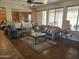 Comfortable living room with large windows and ceiling fan at 15352 W Ventura St, Surprise, AZ 85379