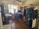 Home office with neutral walls, a desk, custom bookshelf, and a clothing rack at 15352 W Ventura St, Surprise, AZ 85379