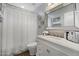 This modern bathroom features a shower-tub combination, updated vanity, and stylish decorative mirror at 16636 S 22Nd St, Phoenix, AZ 85048