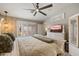 This stylish bedroom features shuttered windows, a ceiling fan, and a wall-mounted television at 16636 S 22Nd St, Phoenix, AZ 85048