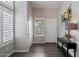 Bright foyer with wood floors, white walls, and natural light from shuttered sidelight window at 16636 S 22Nd St, Phoenix, AZ 85048