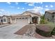 Inviting single-story home with desert landscaping, covered porch, and three-car garage at 16636 S 22Nd St, Phoenix, AZ 85048