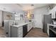 Well-lit kitchen with stainless steel appliances, white cabinets, and stylish backsplash at 16636 S 22Nd St, Phoenix, AZ 85048