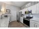Beautiful kitchen featuring stainless steel appliances, white cabinets, and ample counter space at 16636 S 22Nd St, Phoenix, AZ 85048