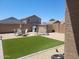 Backyard featuring artificial turf, gravel and backyard seating at 1769 E Jacob St, San Tan Valley, AZ 85140