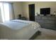 Bright bedroom featuring a comfortable bed and a large dresser with a TV at 1769 E Jacob St, San Tan Valley, AZ 85140