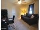 Cozy room featuring a couch, desk and chair and a window with natural light at 1769 E Jacob St, San Tan Valley, AZ 85140