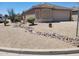 Charming curb appeal with desert landscaping and decorative rock accents at 1769 E Jacob St, San Tan Valley, AZ 85140