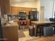 Kitchen with stainless steel appliances, an island with barstools, and ample cabinet space at 1769 E Jacob St, San Tan Valley, AZ 85140