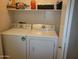 Functional laundry area equipped with a standard washer and dryer with shelving at 1769 E Jacob St, San Tan Valley, AZ 85140